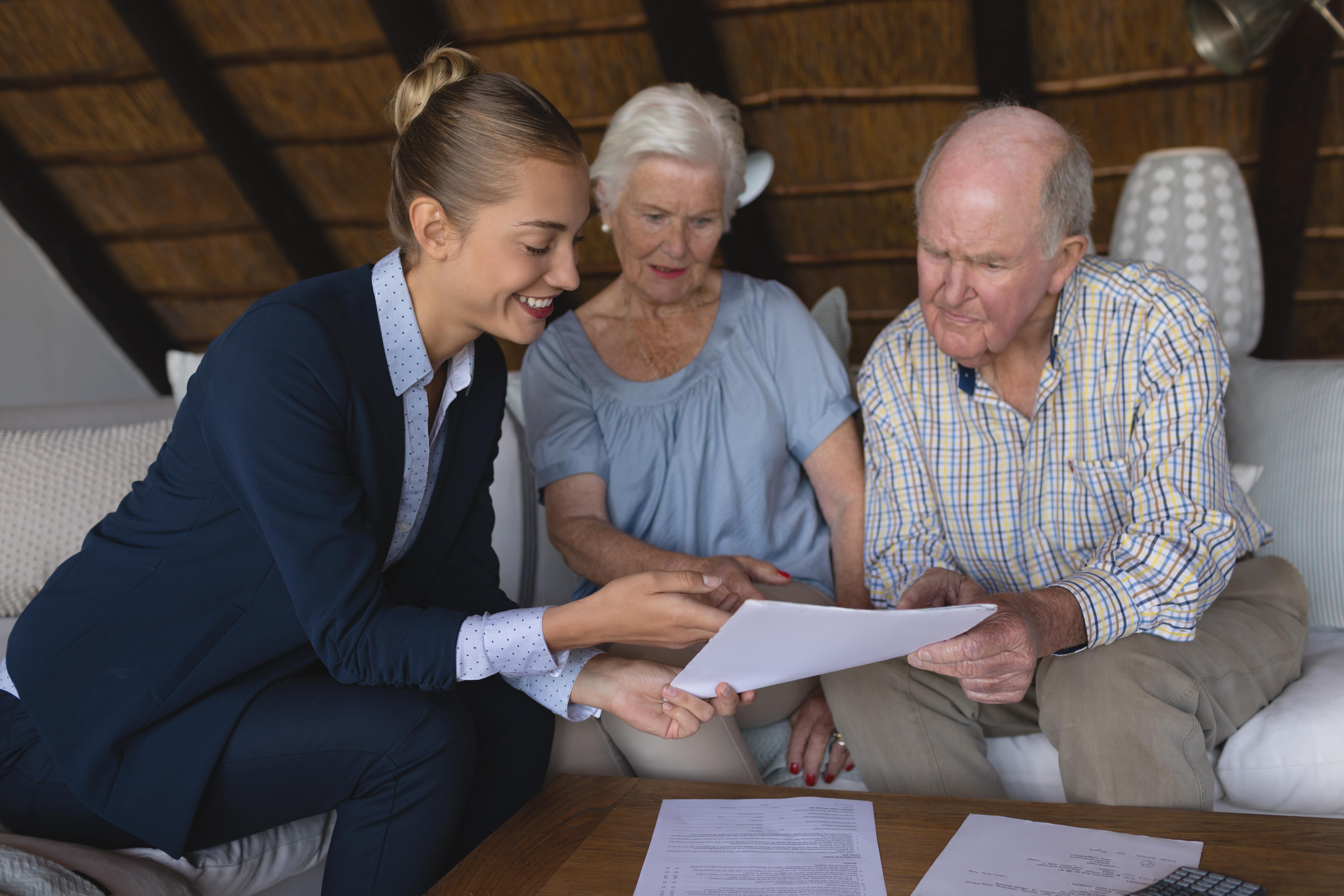 female-doctor-and-senior-couple-looking-and-discus-2023-11-27-05-18-05-utc-min.jpg